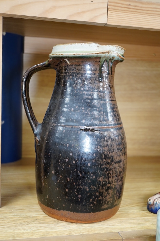 Richard Batterham (1936-2021), a tall Stoneware black glazed jug, with a cream rim, 28cm high. Condition - good